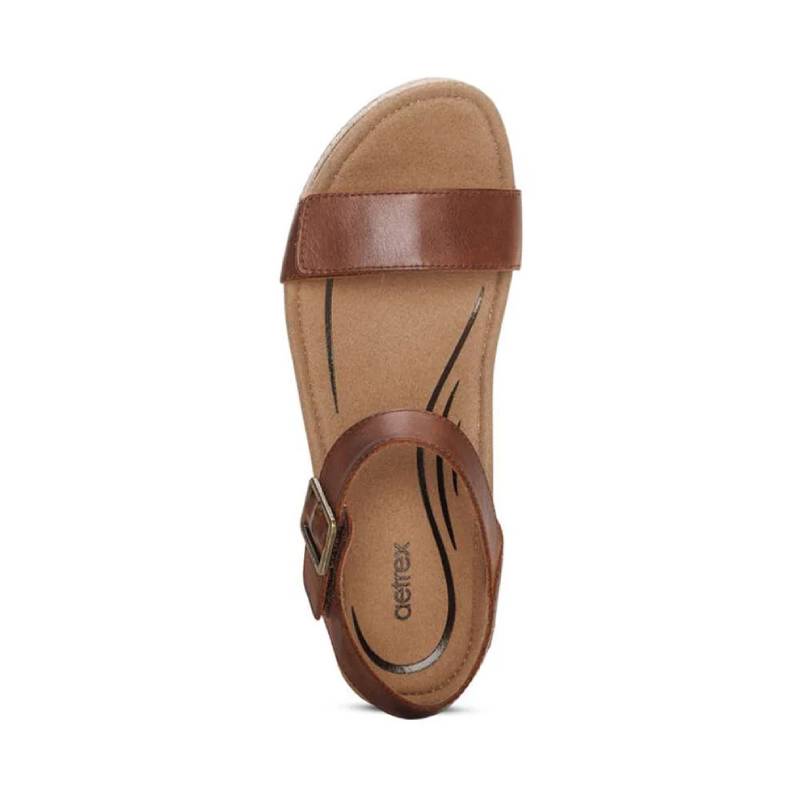 Brown sandal with a single strap on a white background