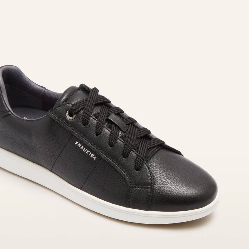 Black leather sneaker with white sole on a white background